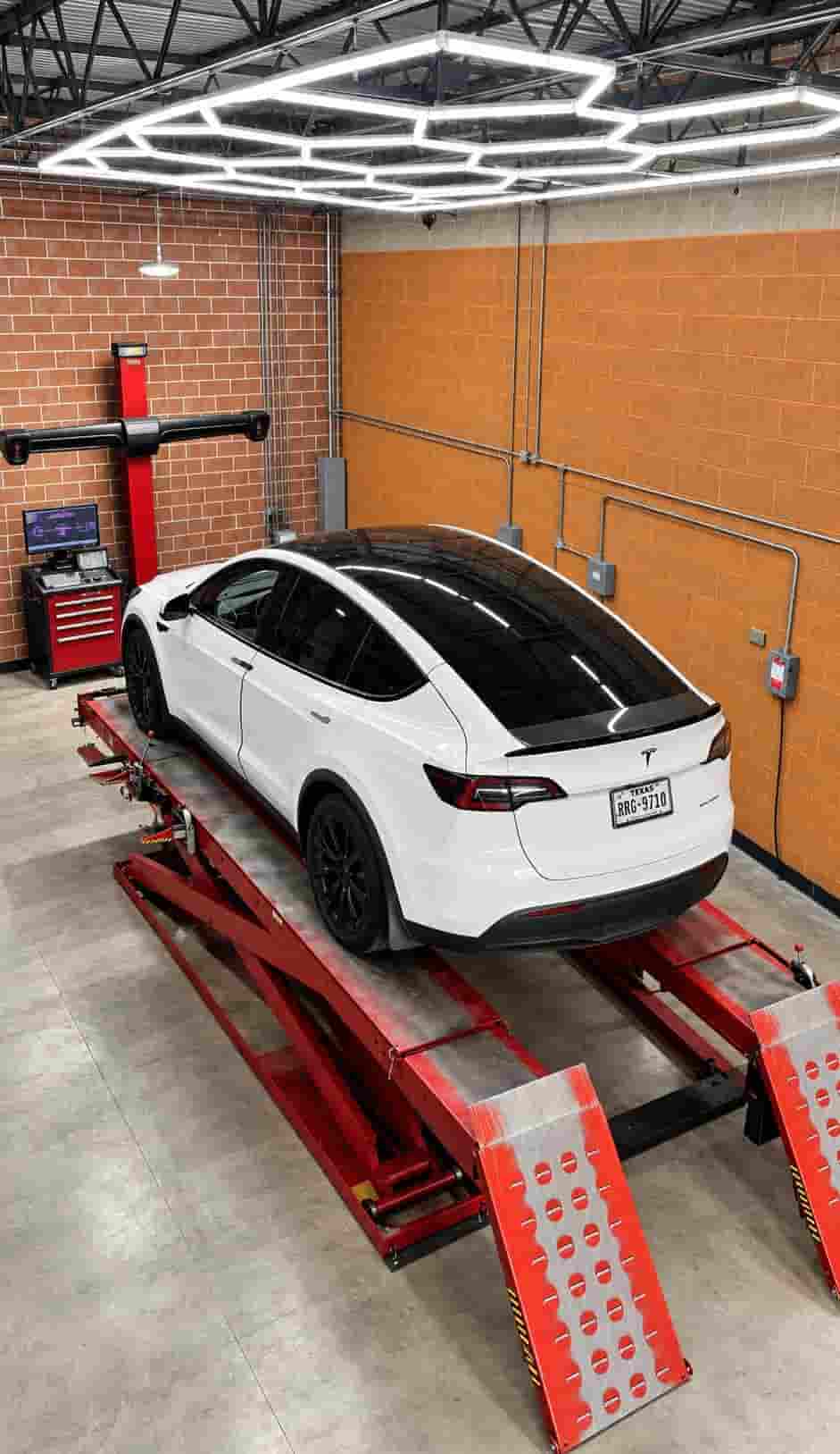 Tesla vehicle at a wheel alignment workshop in Houston
